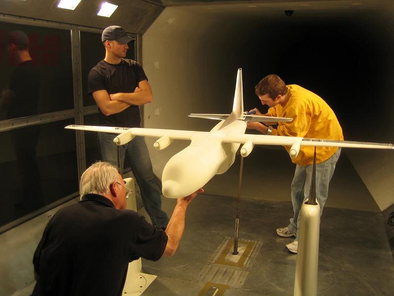 SAI engineers testing a C-130 STOL Herk scale model in a wind tunnel